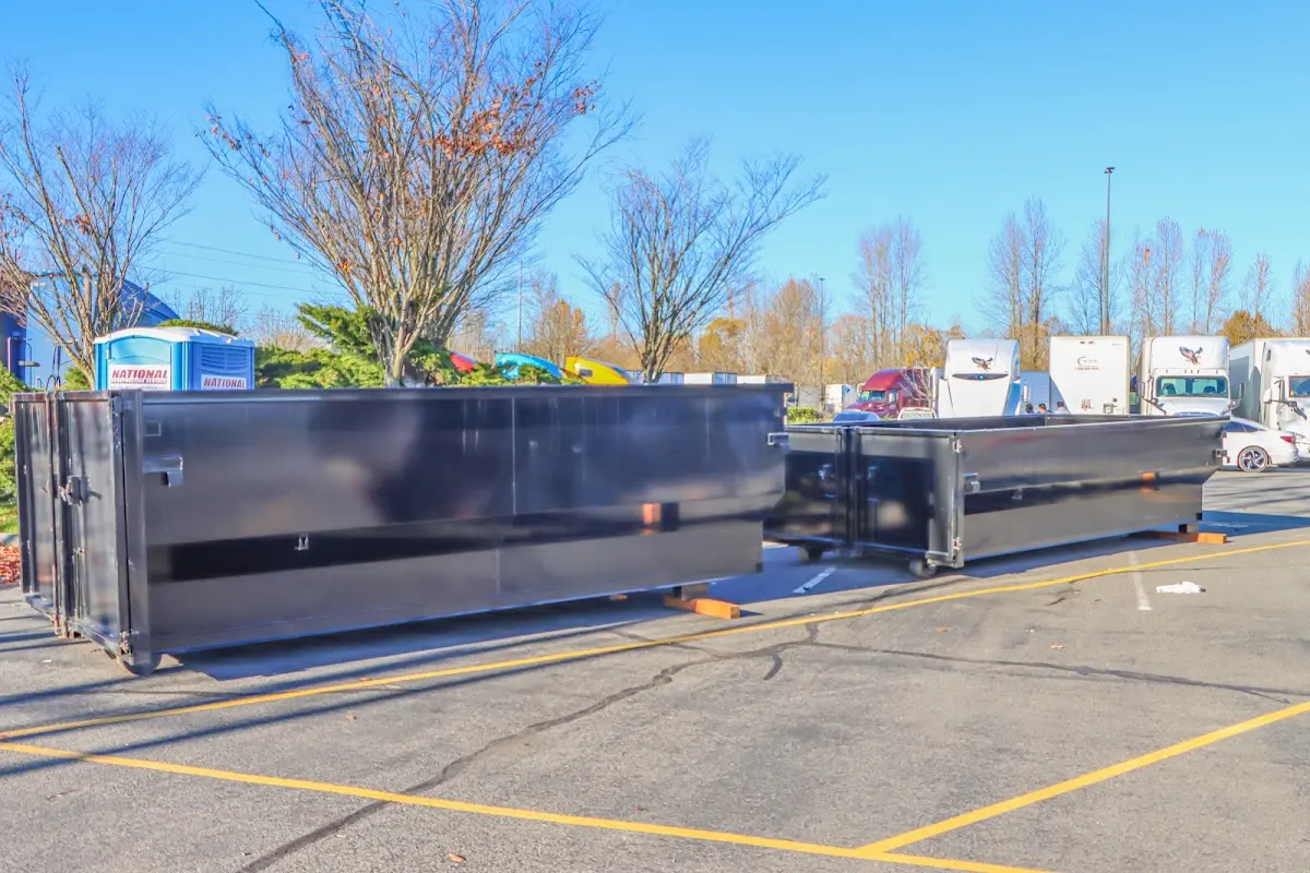 Professional dumpster rental service with roll-off container on residential driveway in Waller